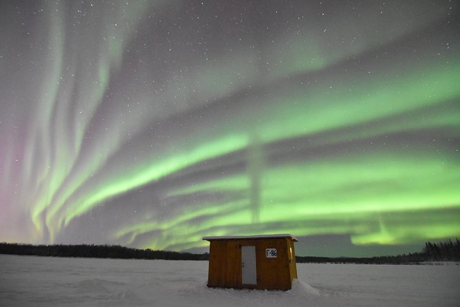 Aurora Borealis Viewing and Ice Fishing Adventure - How ice fishing plays out in the dark: instruction, patience, and tasty results