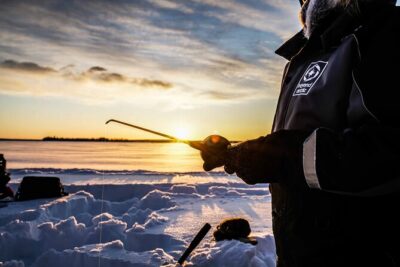 Ice Fishing on a Frozen Lake in Levi - Drilling the ice and fishing: how the “hole strategy” really works