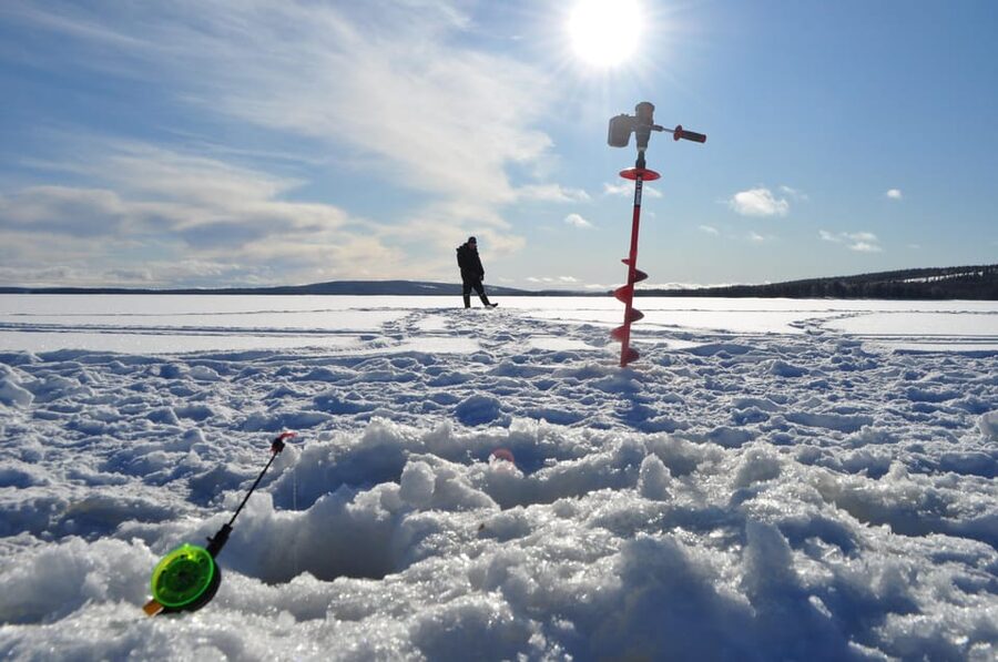 Ice fishing program in Lapland - Making the Hole in Thick Ice: the Hands-On Part That Teaches You Fast