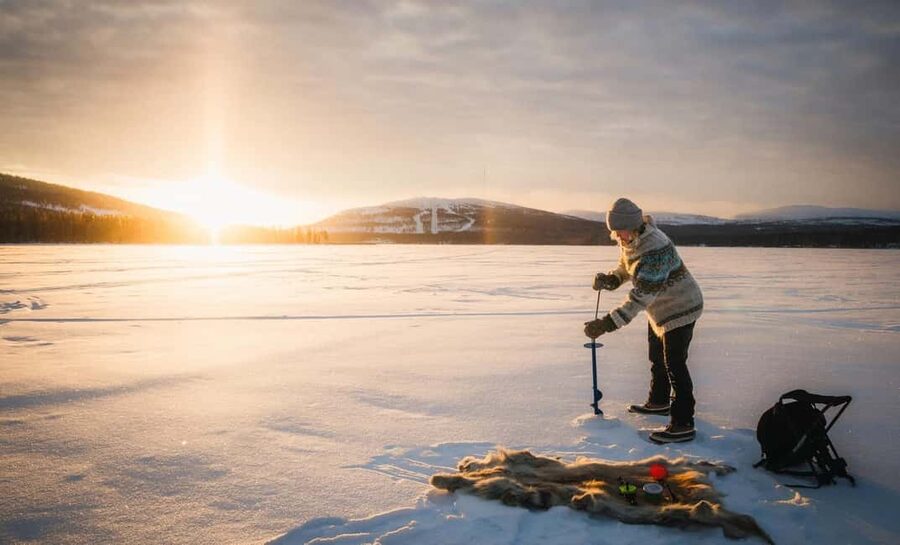 Pyhä: Ice Fishing Experience at Frozen Lake - Drilling the ice hole and learning the traditional Finnish method