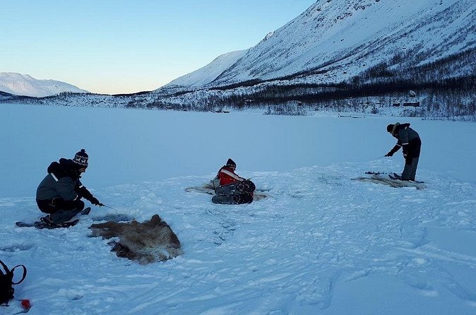 Sjursnes Arctic Ice Fishing Adventure from Tromso - Arriving on the ice: drilling holes and setting up camp